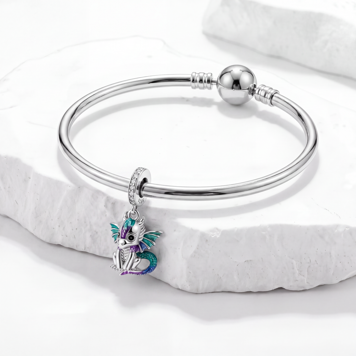 Cute dragon charm on a silver bracelet, perfect for animal charms collection.
