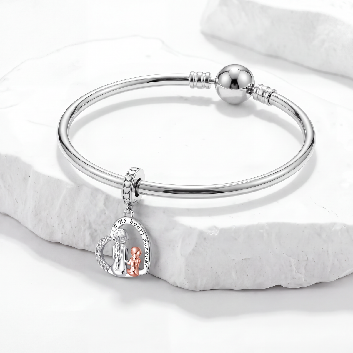 Silver bracelet featuring a family charm symbolizing love and connection, representing family charms.