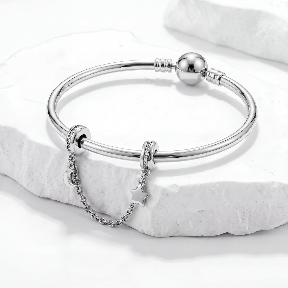 Elegant silver bracelet featuring a Safety Chain Charms to protect meaningful charms.