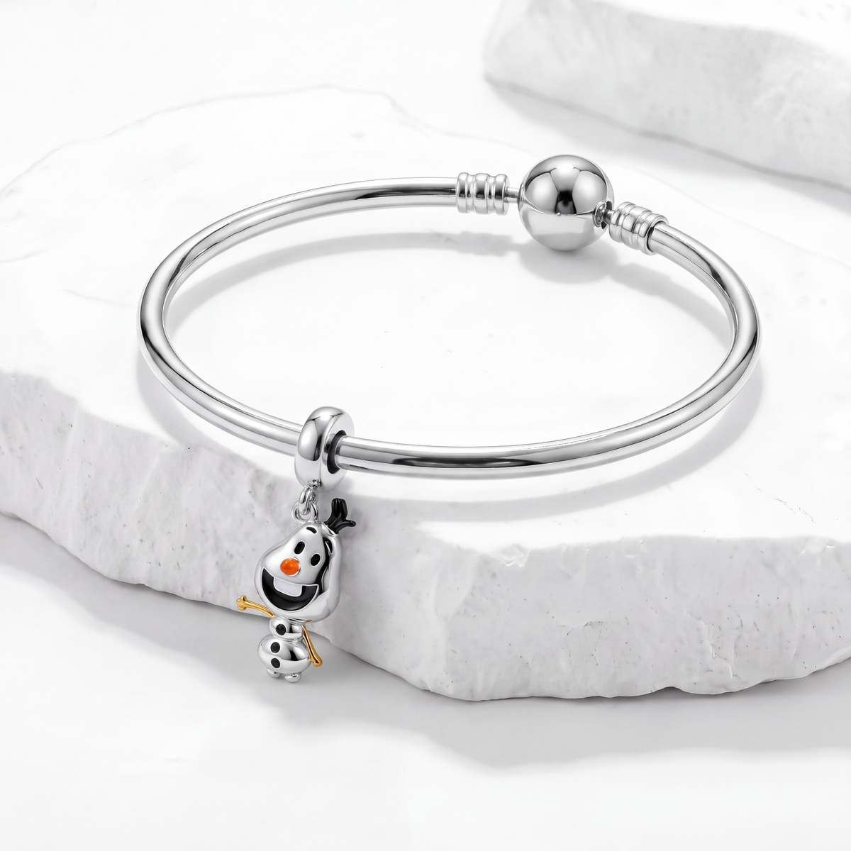 Disney charms bracelet featuring an adorable Olaf charm on a polished silver bangle.