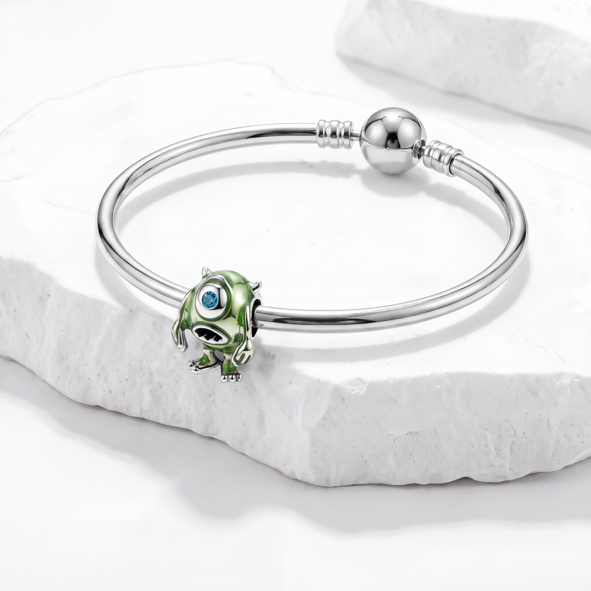 Disney charms bracelet featuring a vibrant Mike Wazowski charm with big eye on a silver band.