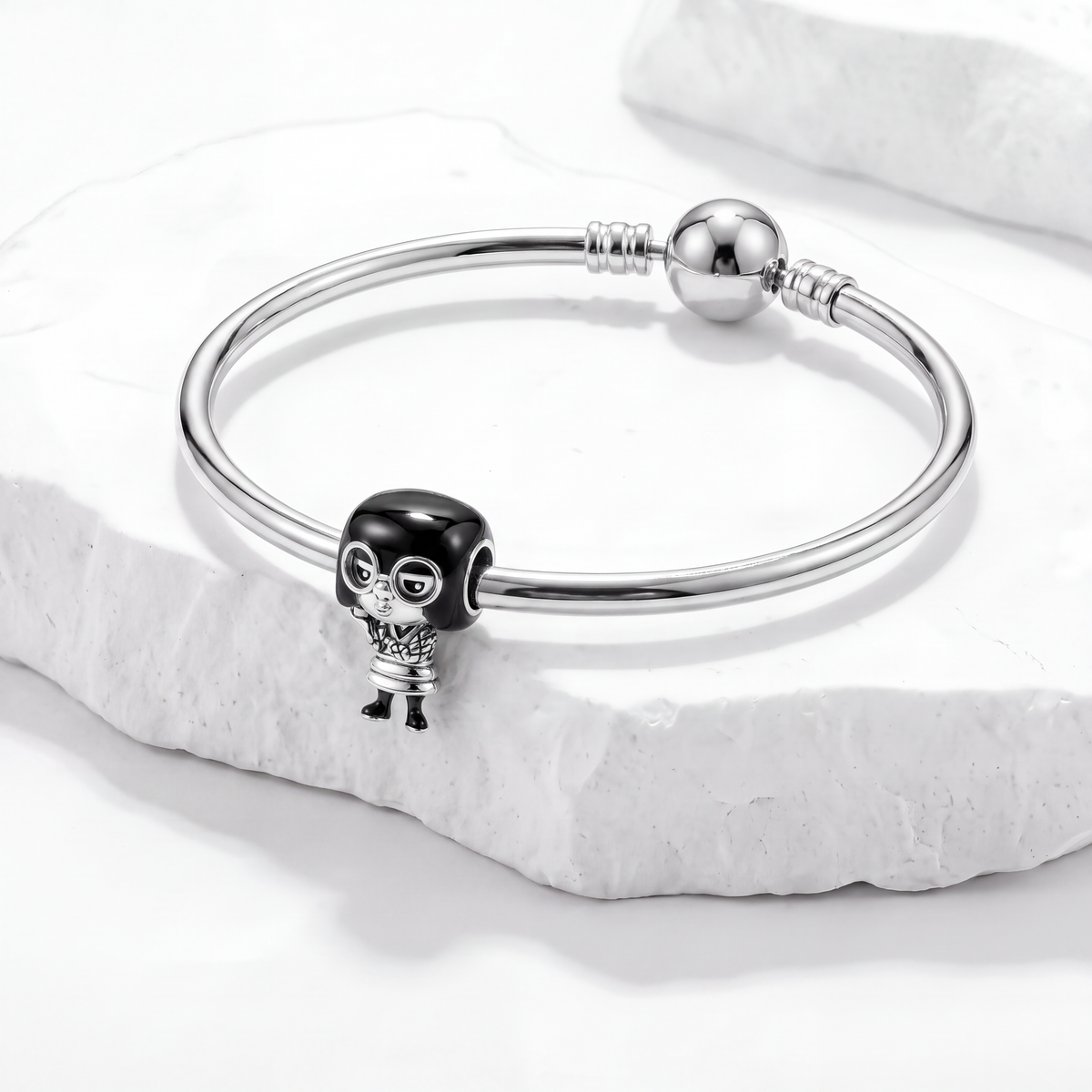 Disney charms bracelet featuring a character with a stylish design on a marble background.