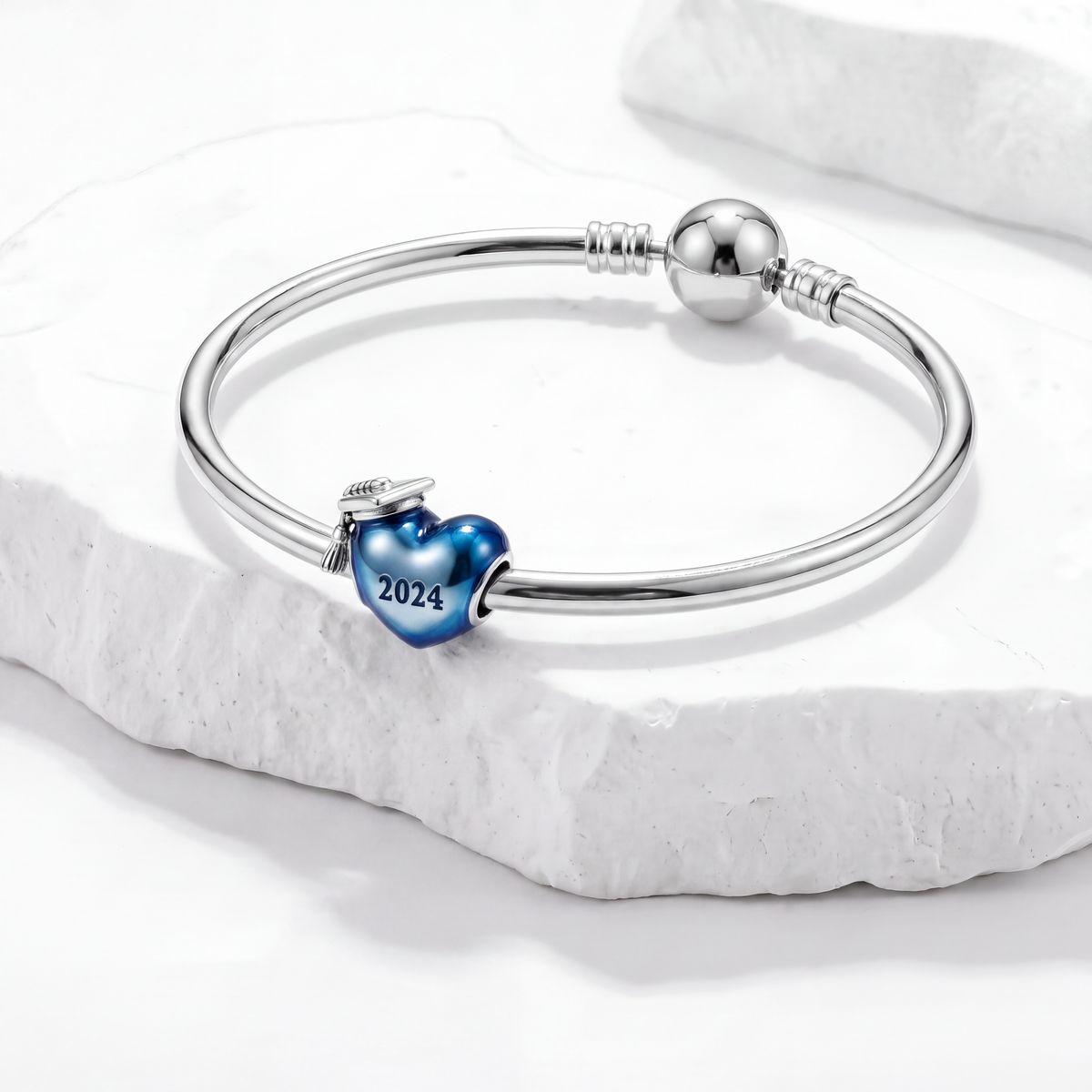Discontinued products jewelry featuring a silver bracelet with a blue heart charm inscribed 2024.