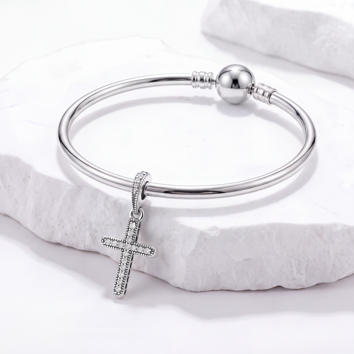 Silver bracelet featuring a cross charm from the Faith Charms collection.