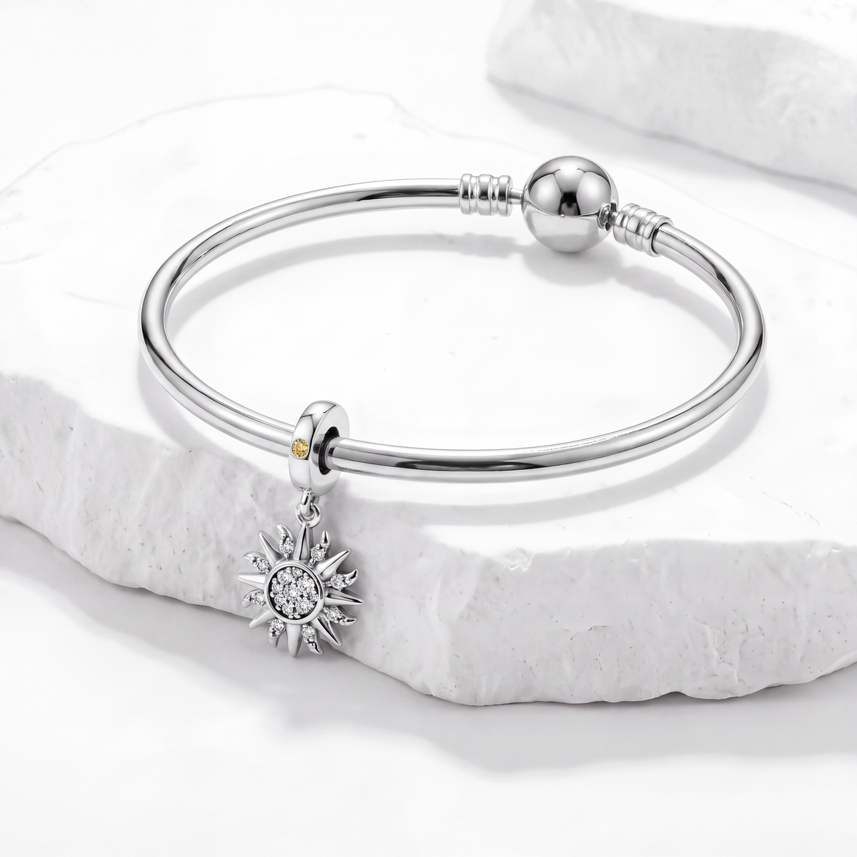 Beautiful silver bracelet featured in the Celestial Charms collection with sun charm detail.