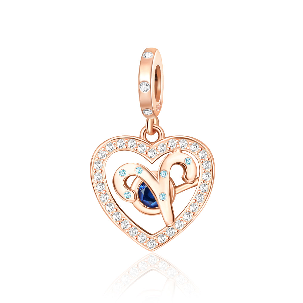 Rose Gold Sparkling Aries Dangle Charm with pavé crystals and sapphire center stone in heart frame.