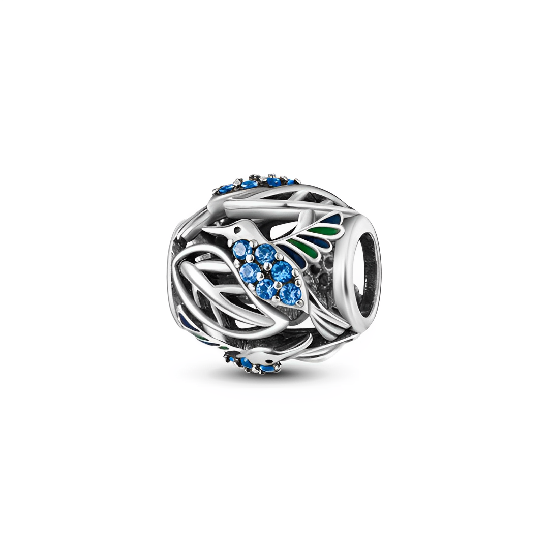 Blue Hummingbird Openwork Nature Charm featuring a silver design with a sparkling blue hummingbird and green enamel tips.