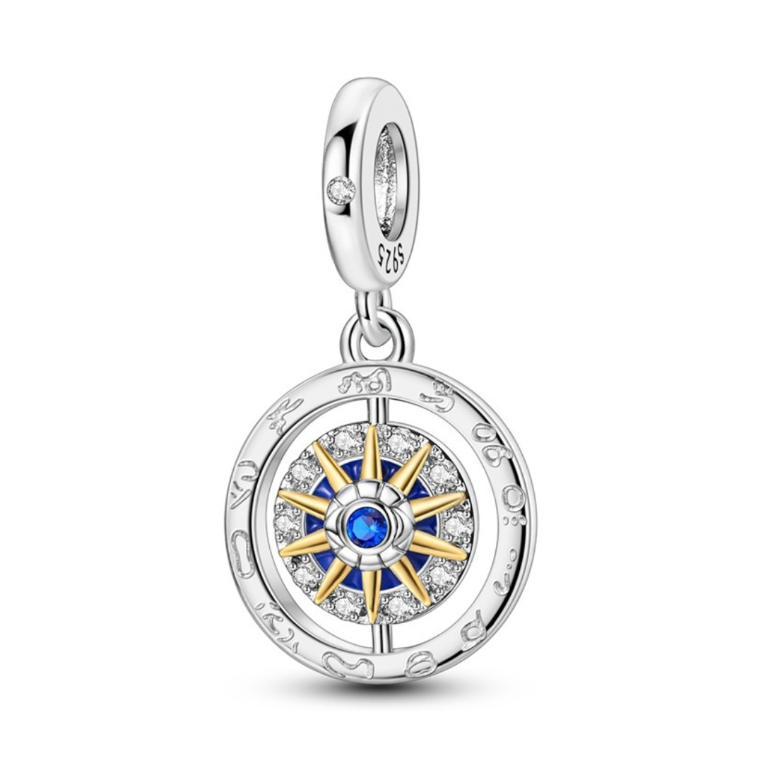 Follow Your Heart Spinning Compass Dangle Charm featuring a gold star compass with blue enamel and sparkling pavé.