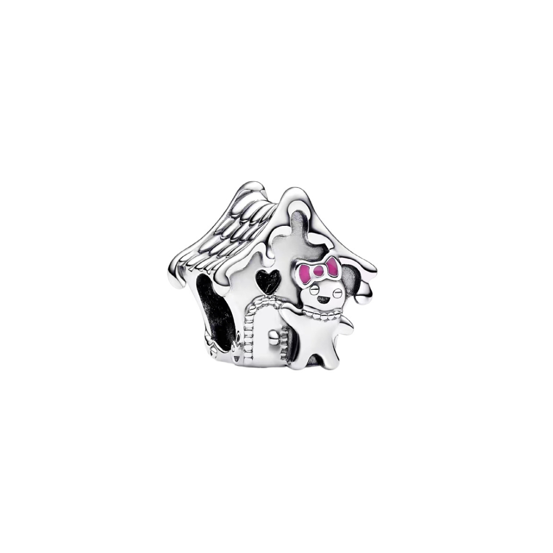 Gingerbread House Christmas Charm featuring a detailed house and a gingerbread woman with a pink bow.