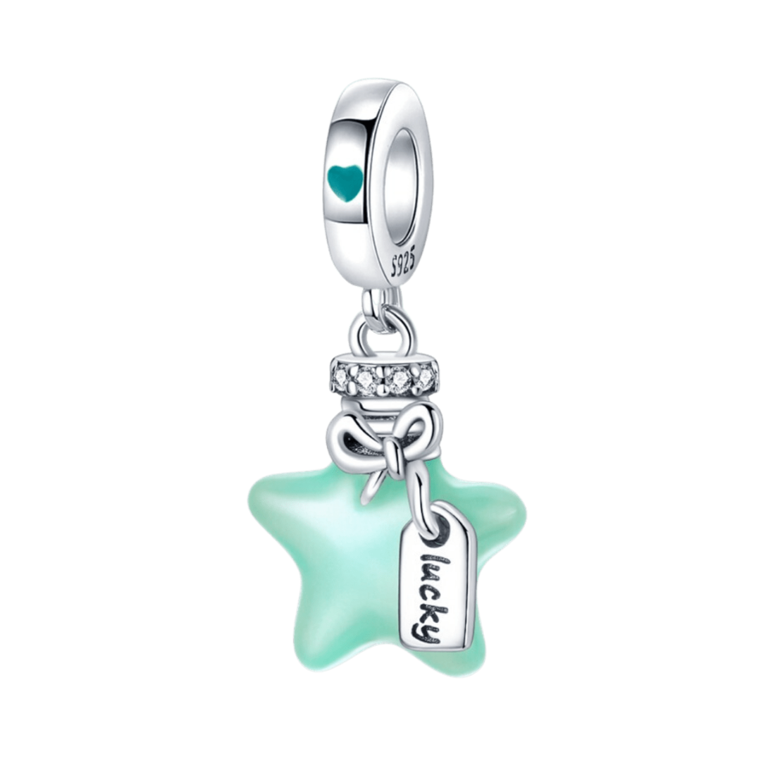 Glow In The Dark Lucky Star Dangle Charm featuring a mint star, bow, and 'lucky' tag gleaming in light.