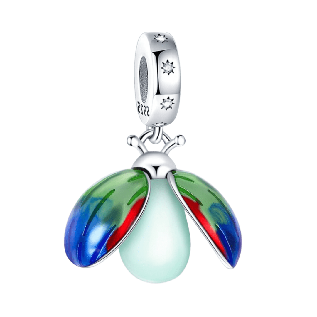 Glow Lady Bug Dangle Charm ( Discontinued ) with vibrant red, green, and blue enamel wings and glowing body.