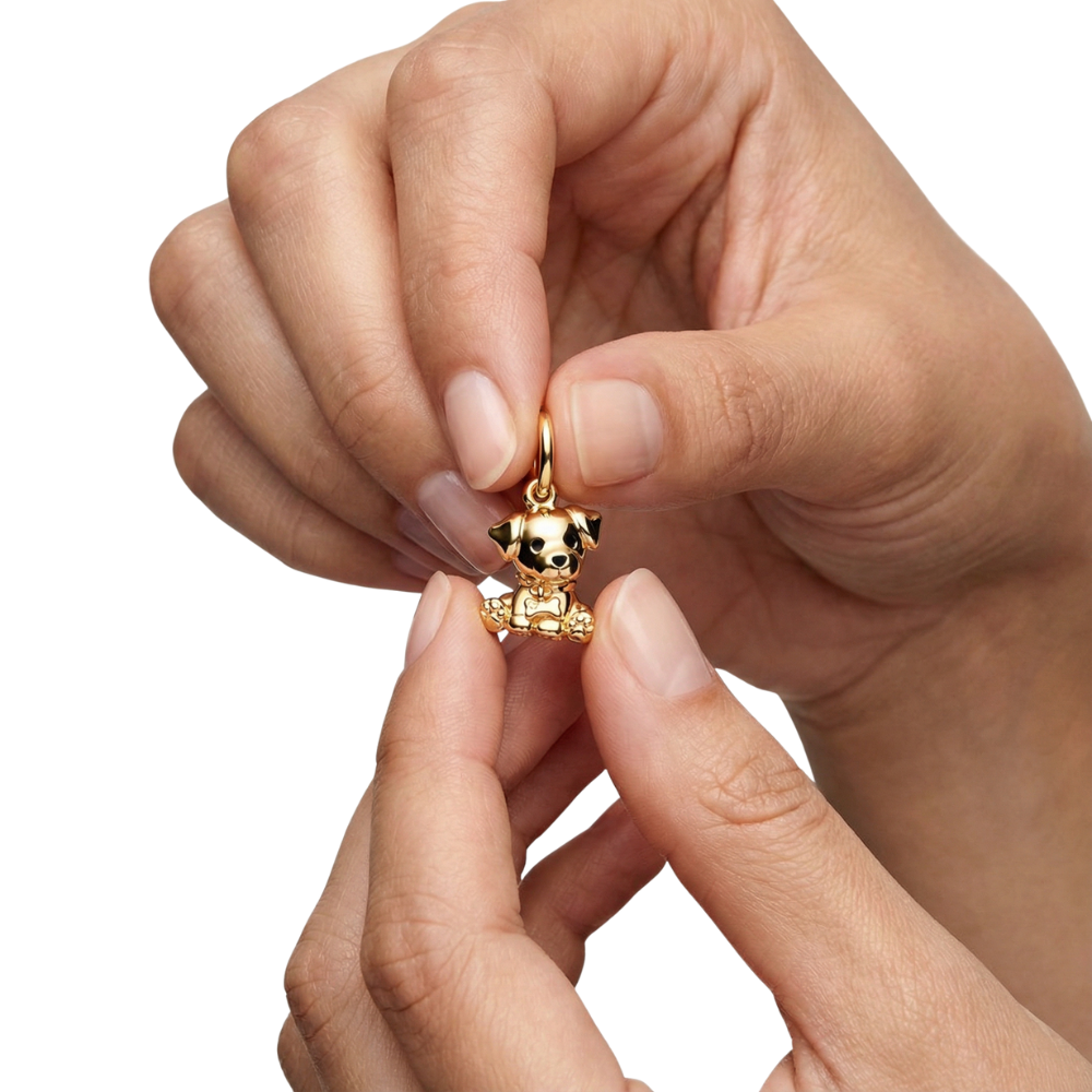Person holding the Golden Cute Puppy Pendant charm showcasing its adorable design and golden shine.