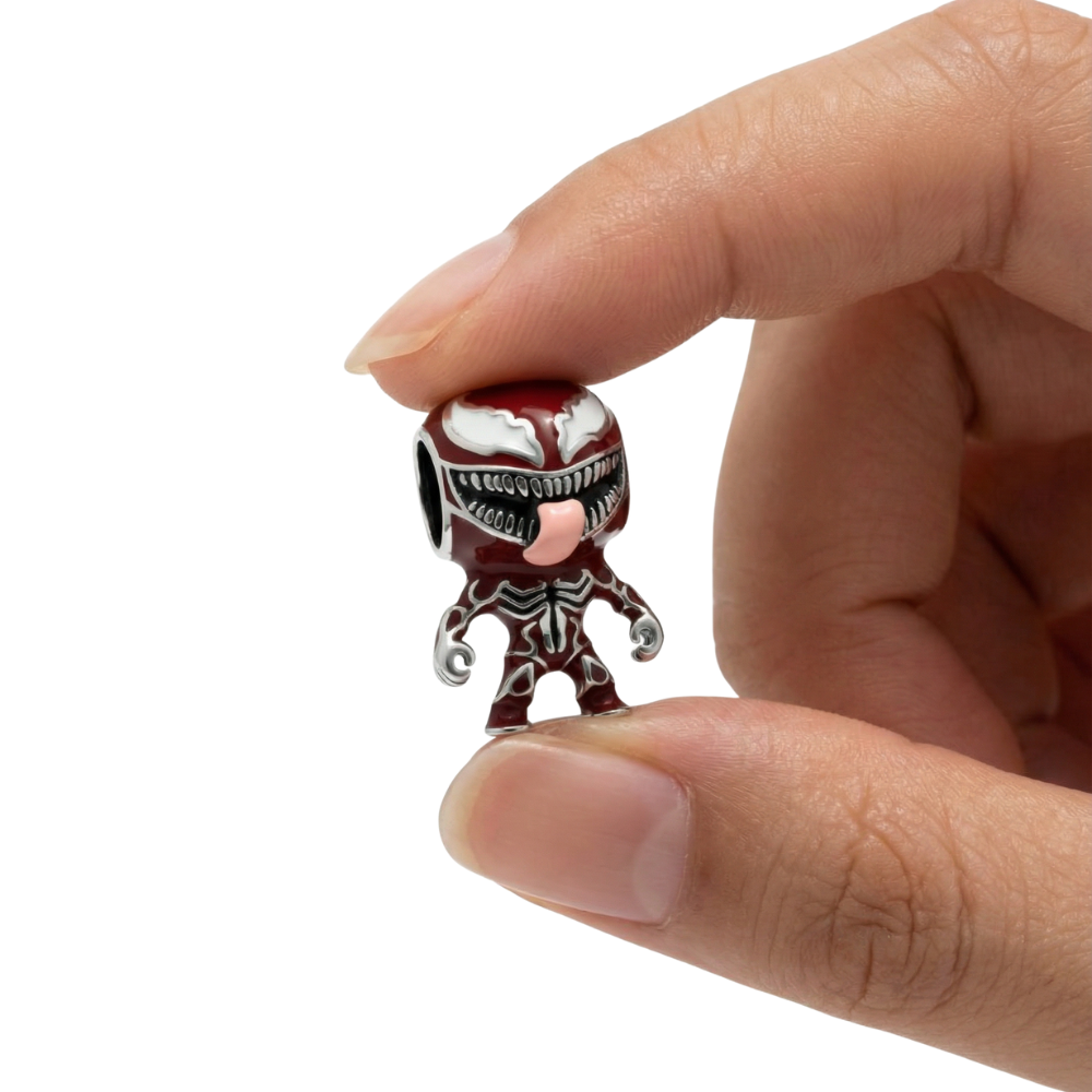 Close-up of a hand holding the Marvel Carnage Symbiote Charm, showcasing its bold design and unique details.