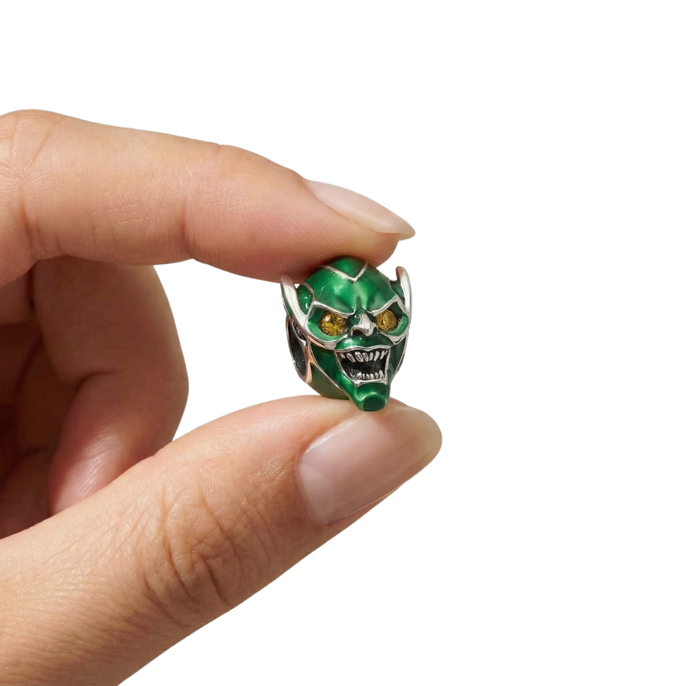 Marvel Spider-Man Green Goblin Mask Charm held between fingers, featuring intricate details and vibrant colors.