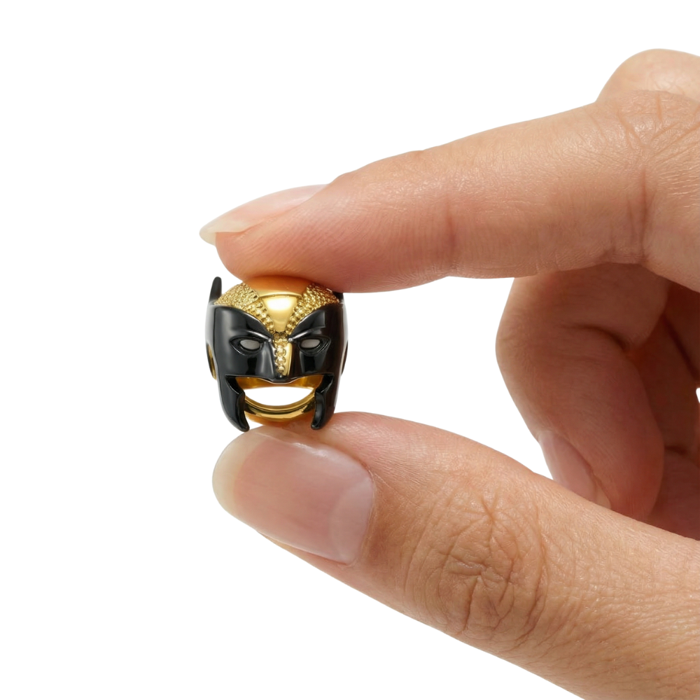 Marvel Wolverine Mask Charm held between fingers, showcasing its powerful design and vibrant colors.