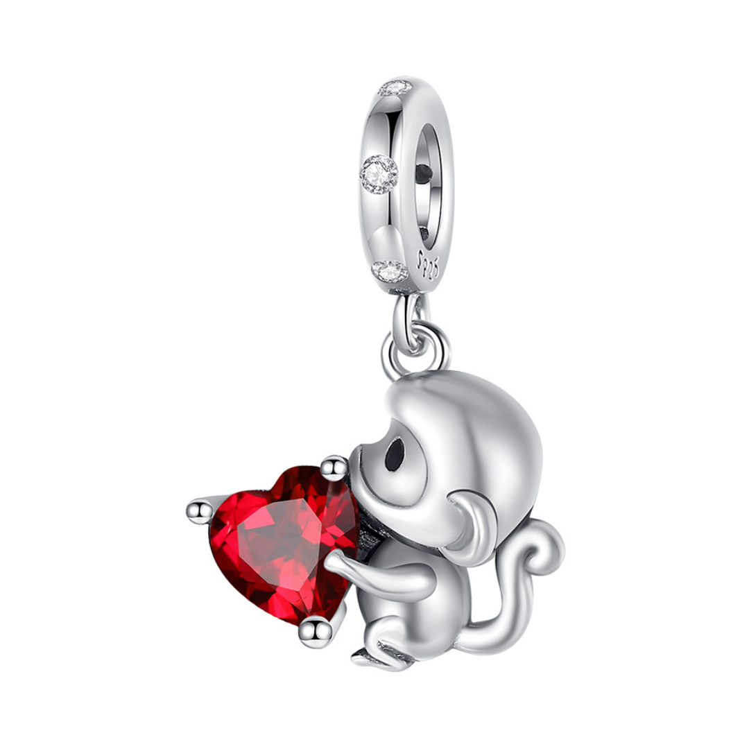 Monkey Love Red Heart Dangle Charm featuring a silver monkey holding a red heart crystal.