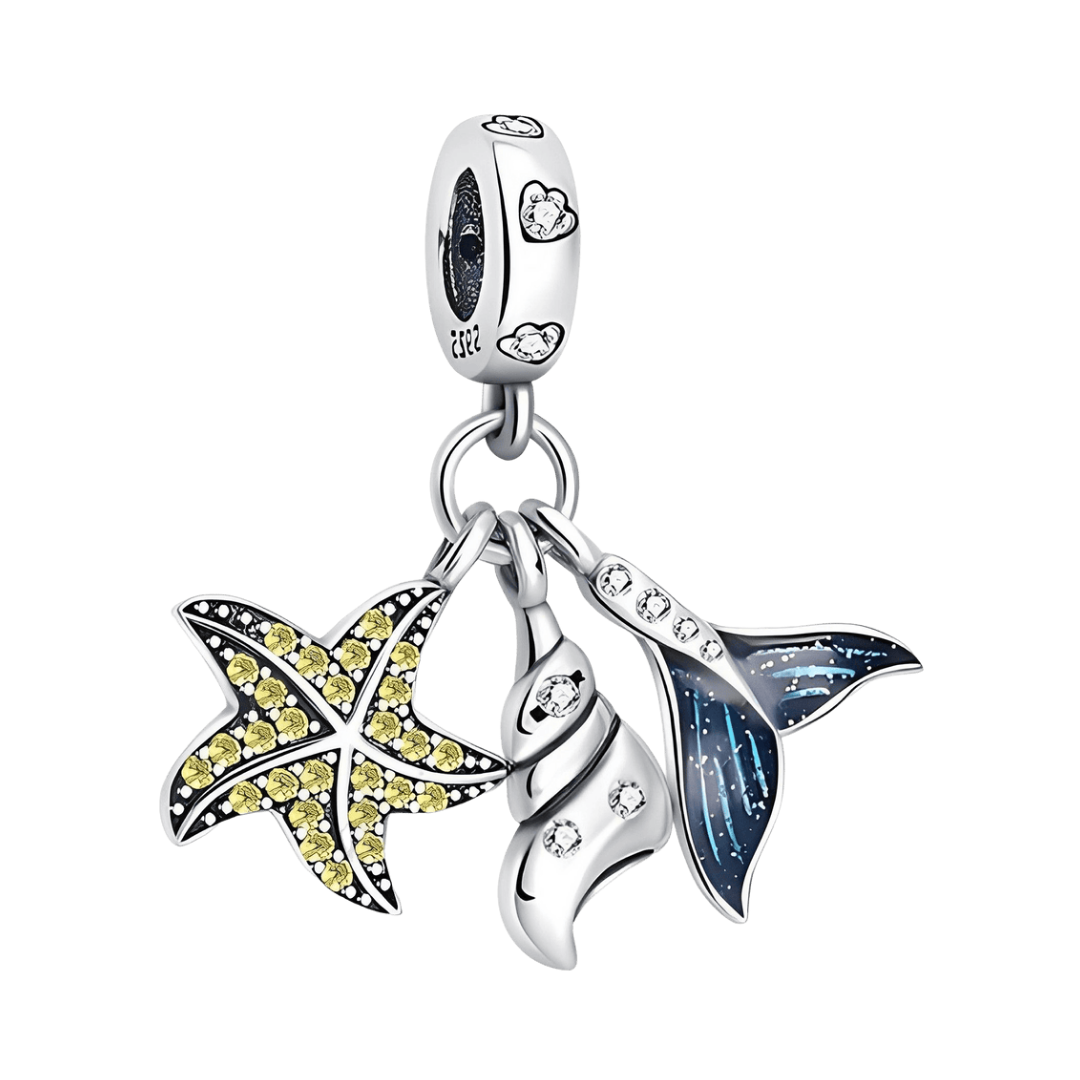 Ocean Treasures Dangle Charm featuring starfish, shell, and mermaid tail designs with sparkling detail.