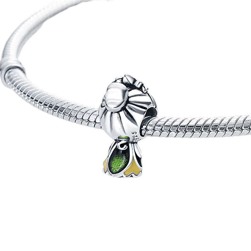 Disney Princess and the Frog Tiana Charm featuring detailed green enamel and gold accents on a bracelet.