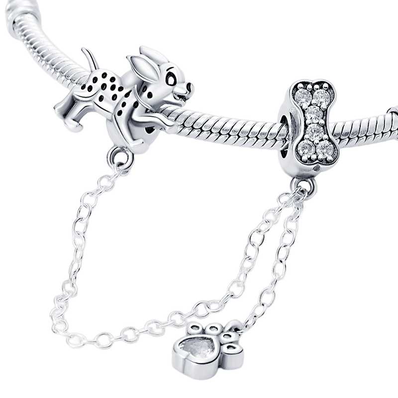 Puppy Paw Safety Chain ( Discontinued ) features a playful puppy and sparkling bone charms connected by a delicate chain.