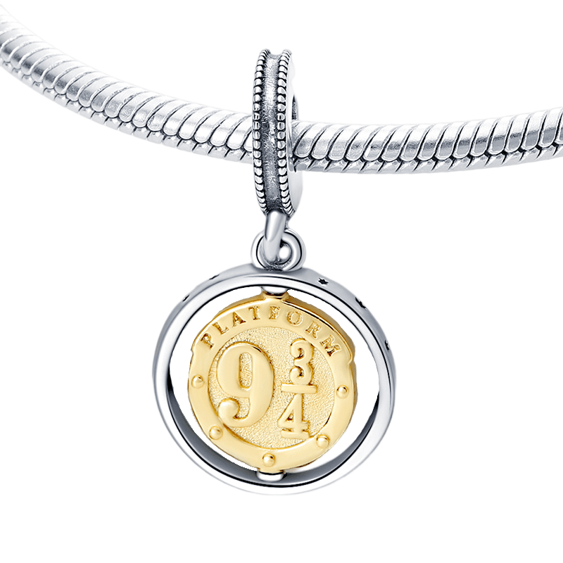 Harry Potter Platform 9¾ Dangle Charm on a silver charm bracelet with golden detail.