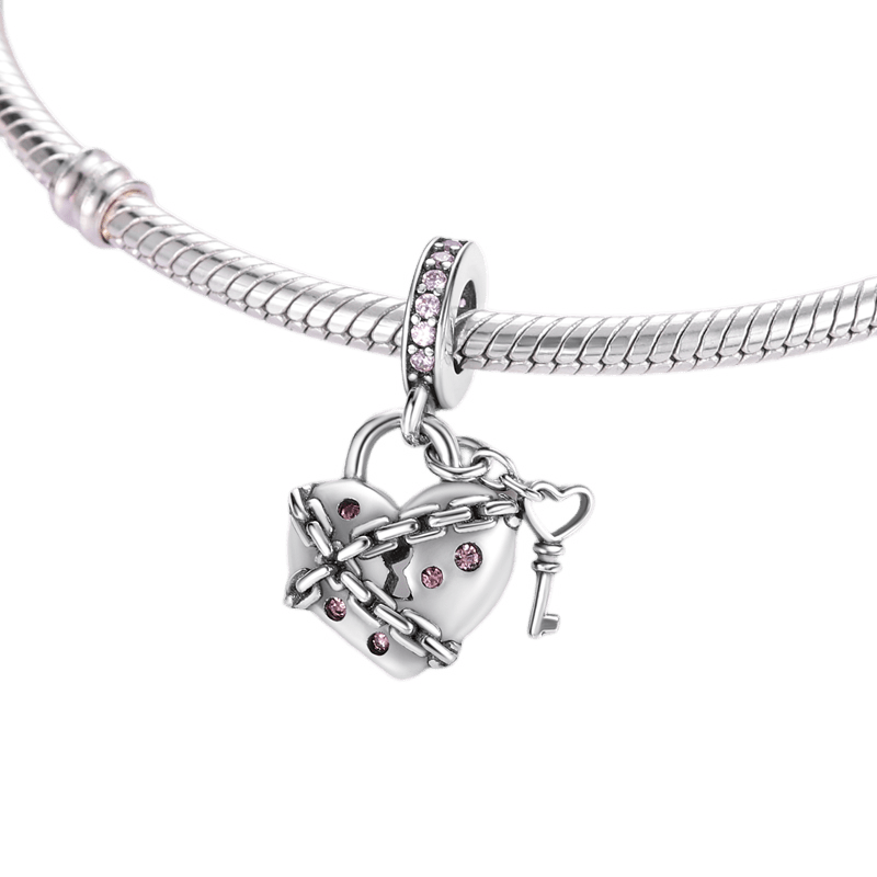 Locked Heart Dangle Charm (DISCONTINUED) featuring a sterling silver heart charm with pink zircon accents and chain design.