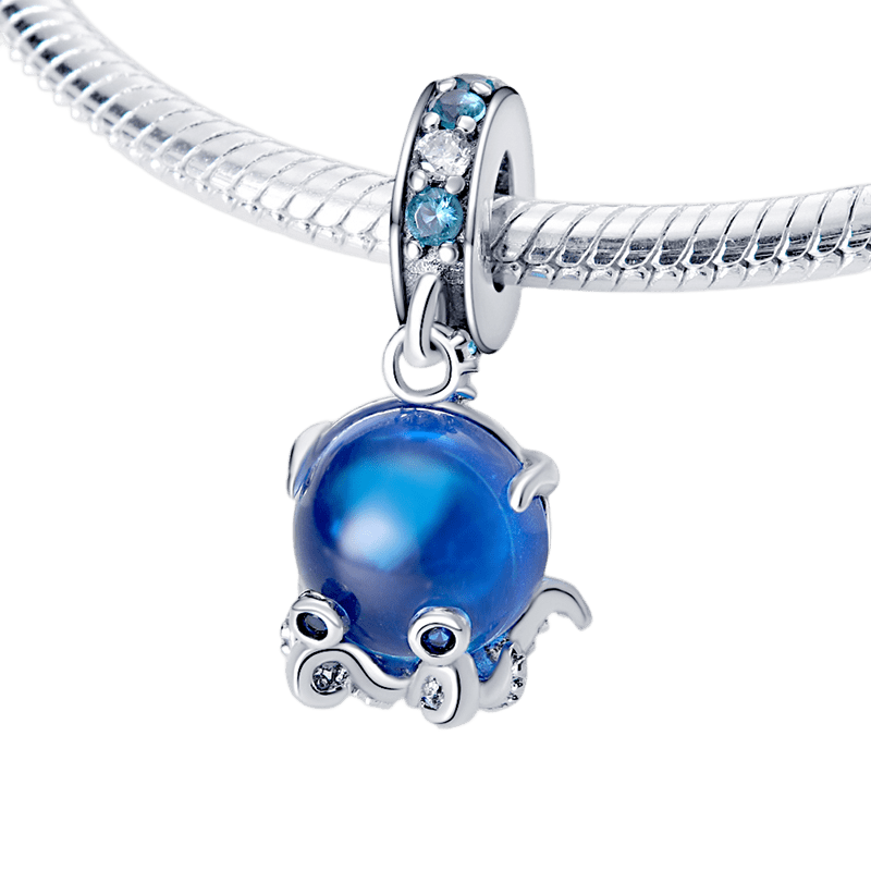 Blue Murano Glass Octopus Dangle Charm on a silver chain with blue stone details.