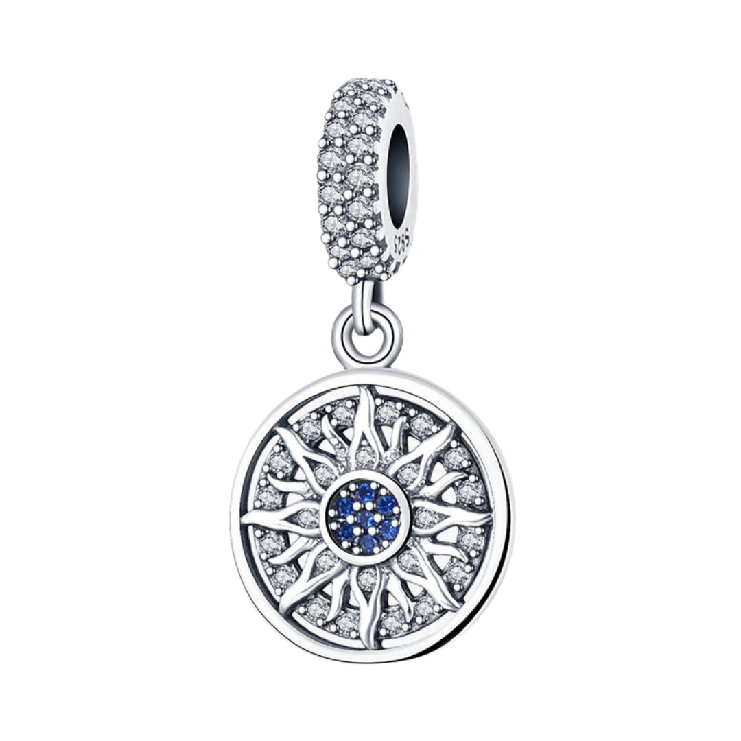 Radiant Sun Mandala Dangle Charm with intricate silver sun rays and sparkling blue stone center.