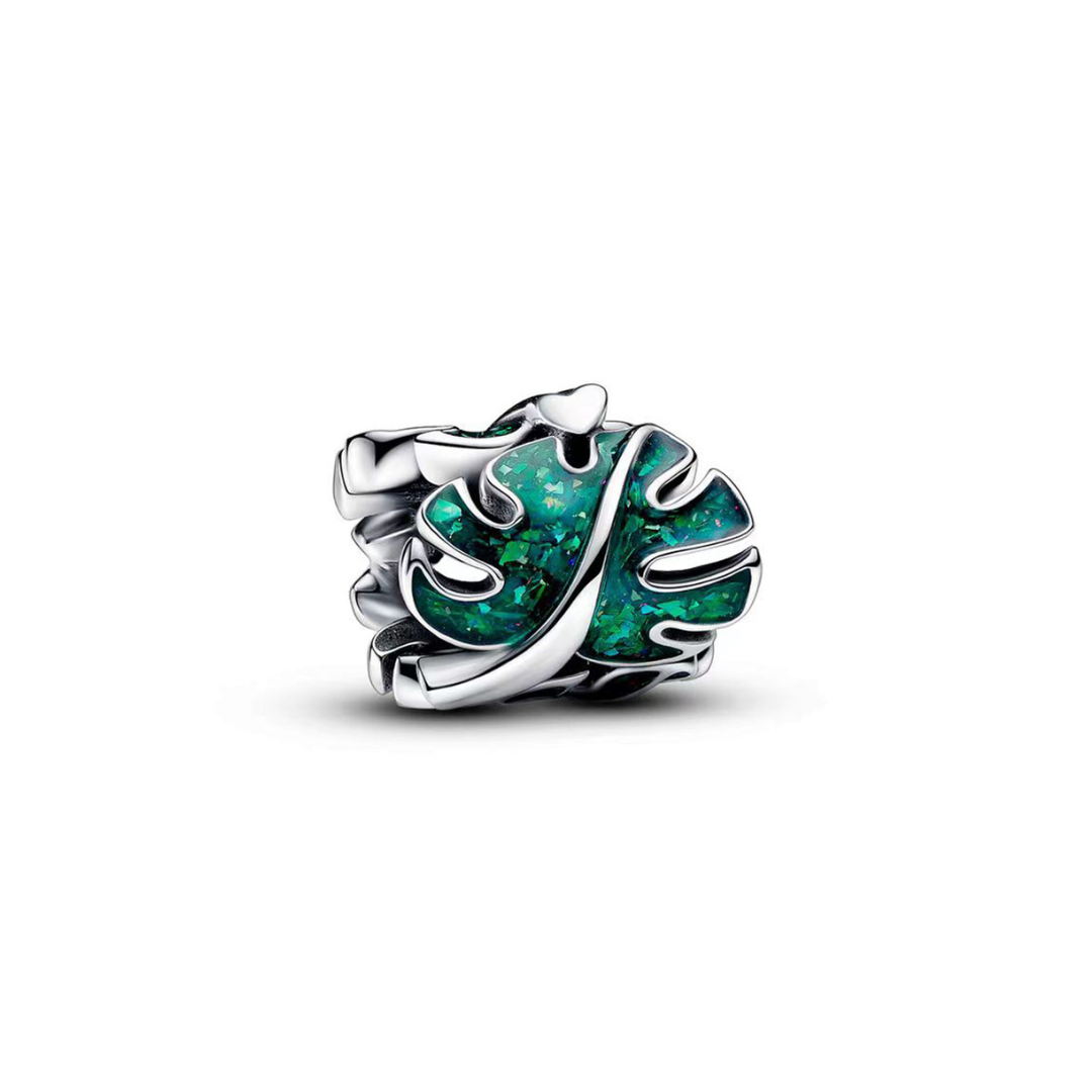 Shimmering Tropical Monstera Leaf Charm in shimmering opalescent green with silver detailing, perfect for plant lovers.