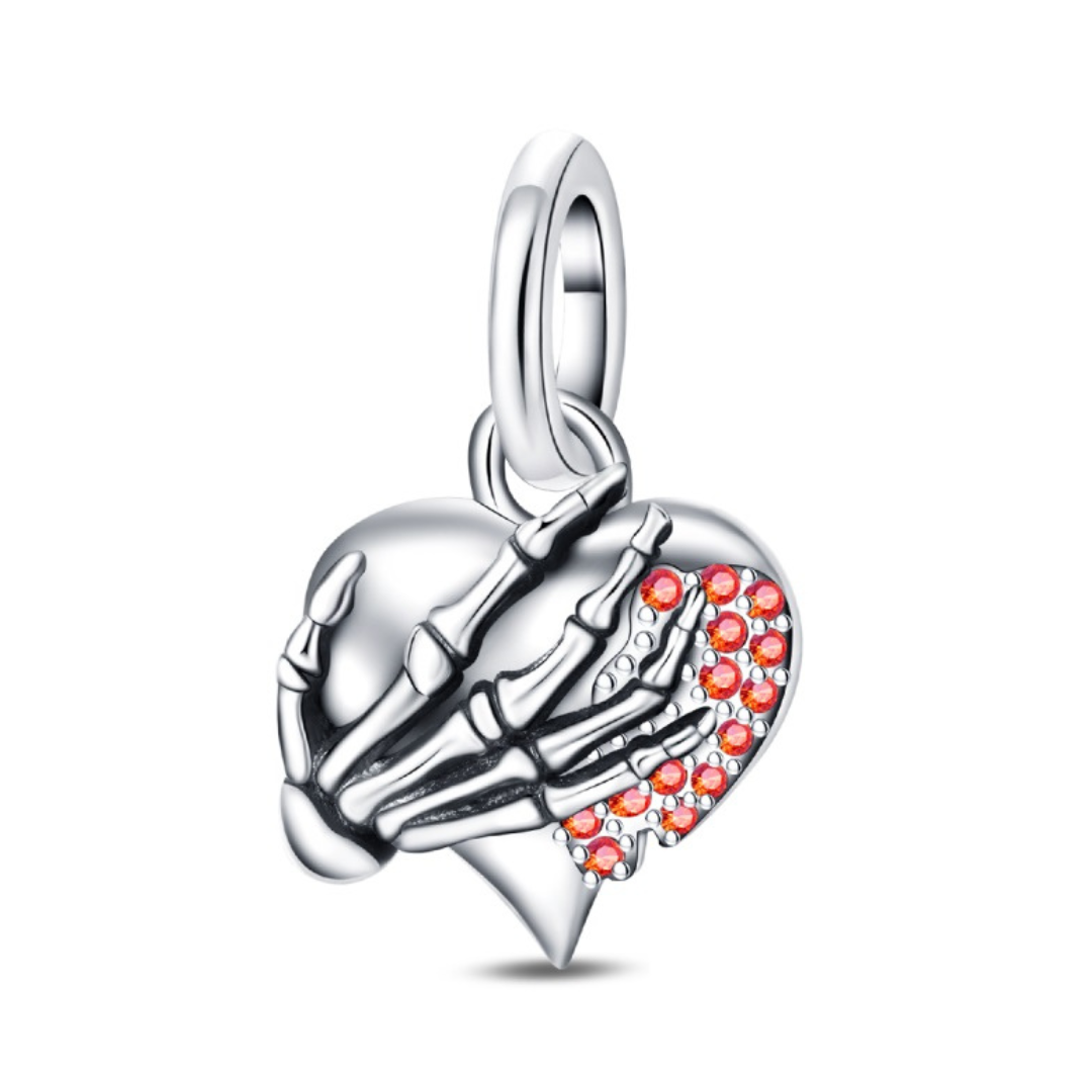 Skeleton Hand Sparkling Heart Pendant featuring a skeleton hand clutching a silver heart with sparkling red pavé.