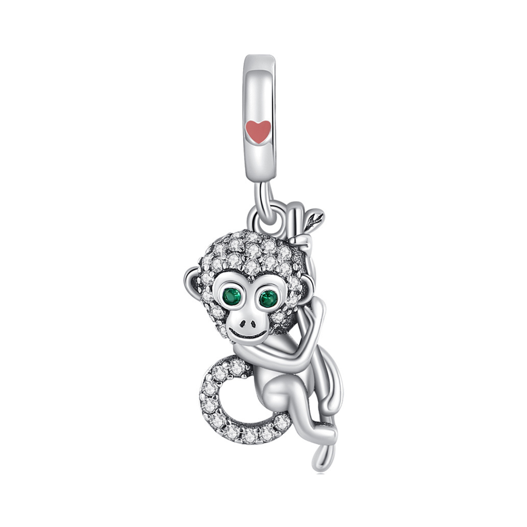 Sparkling Monkey Dangle Charm featuring a playful monkey with crystal details and green eyes.