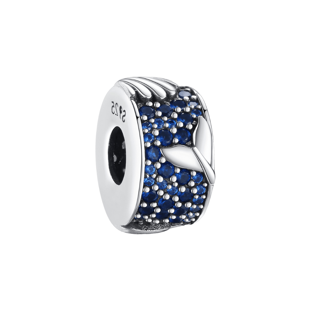 Tail and Seashell Barrel Charm ( Discontinued ) featuring a sterling silver design with blue zircon stones and a whale tail.